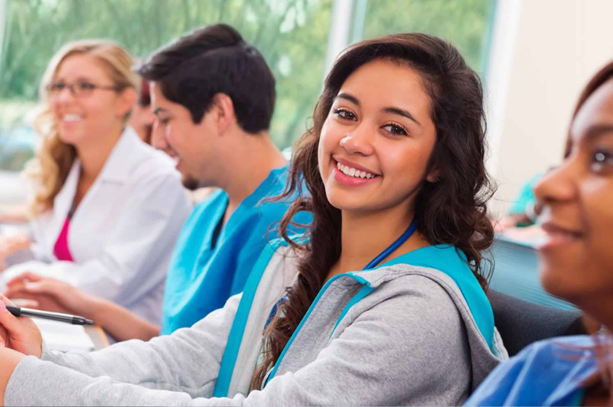Student smiling with other students in background